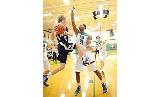 On Feb. 11, the visiting Bishop Eustace Prep boys’ basketball team beat Camden Catholic High in an overtime thriller in Cherry Hill, by a score of 56-50. Above, the Crusaders’ Pat Fish drives to the basket, in front of the Irish’s Chris Okafor.

Photo by Alan M. Dumoff, more photos ccdphotolibrary.smugmug.com