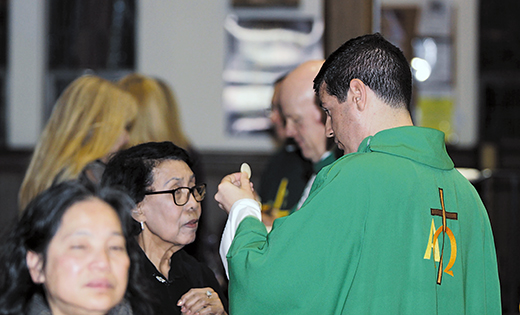 Our Lady Star of the Sea Church in Atlantic City played host to a special Mass of Solidarity with Working Families on Feb. 3. The Mass, which welcomed members of Unite Here Local 54, was followed by a march through Atlantic City. Father Jon Thomas, right, pastor of Saint Monica Parish, distributes the Eucharist during the Mass. Though unable to attend due to illness, Bishop Dennis Sullivan’s homily was read in his absence. Through Father Robert Hughes, Vicar General, he preached to those in attendance that “the social teaching of the Catholic Church is clear on the dignity of labor and its importance to the human person.” He also noted that since 1891 popes have regularly commented on the necessity of “workplace associations and organizations” created to improve the lives of all workers.

Photo by Mike Walsh