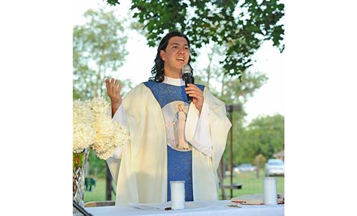 Father Ariel Hernandez, pastor of Our Lady of the Blessed Sacrament, Newfield, celebrates Mass for workers at Cheli Farms, Minotola, on Aug. 11.