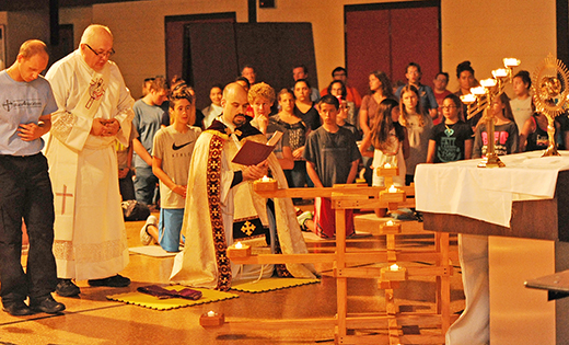 Assisted by seminarian Anthony Infanti and Deacon Don Rogozenski, Father Michael Goyette, parochial vicar at Northfield’s Saint Gianna Beretta Molla Parish, leads the “Burning Bush” adoration service for Summer in the City youth participants on Aug. 18 in the parish hall.

Photo by Alan M. Dumoff