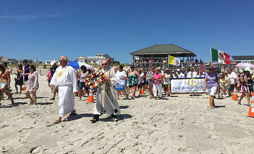 Father Mark Cavagnaro, pastor of Saint Brendan the Navigator Parish, Avalon, leads the procession to the shores of Stone Harbor during the city’s Wedding of the Sea celebrations last Sunday evening, the vigil of the feast of the Assumption.

Photo by Maria D’Antonio