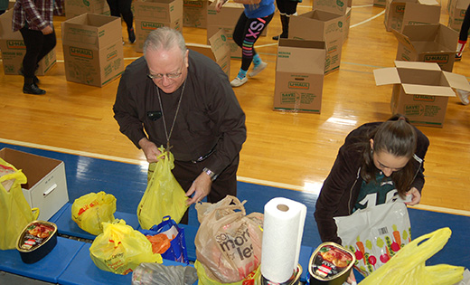 Photo by Peter G. Sánchez

Bishop Dennis Sullivan works next to senior Francesca Graziano packing Thanksgiving baskets in the gym of Paul VI High School on Nov. 22. The Haddon Township school partnered with Holy Name School to provide 50 families of the north Camden school a happy Thanksgiving. Parishes, schools and organizations, as well as Catholic Charities, work to help the less fortunate every Thanksgiving.