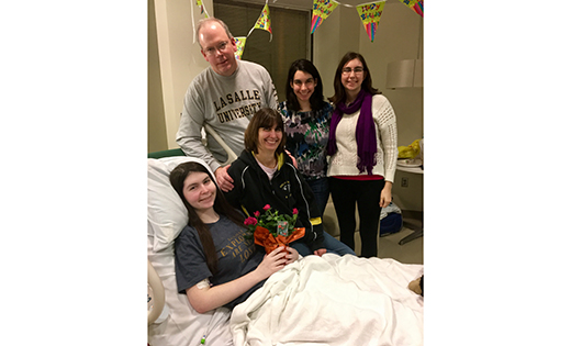 Kevin and Peggy Buck and their daughters Catherine and Maggie gather at Aimee’s hospital bed.