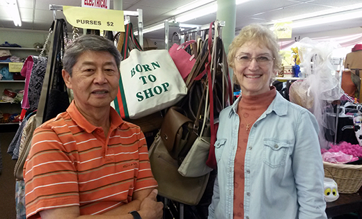 Store manager Dennis Chang stands with Cathy Rainey, president of the Saint Simon Conference of the Society of Saint Vincent de Paul, in the Saint Vincent de Paul Thrift Store in Berlin.