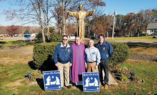 Councils 7463 (Shane’s Castle) and 7774 ( Father Harold Koeppen) of Christ the Redeemer Parish  of Atco have donated signs to be given out at all Masses to parishioners. The signs highlight the spirit of Christmas and the need for peace on earth. Shown displaying the signs are, from left, Joseph E. Benton Jr,, project coordinator, Father Thomas Barcellona, pastor, Chuck Craig, Grand Knight Council 7774 and Robert Hayes, Grand Knight Council 7463.