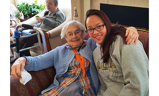 Julie Nguyen of Our Lady of Mercy Academy, Newfield, poses for a photo with a resident of Maurice House in Millville. The school’s Interact Club visited the facility Dec. 19 to play bingo, decorate cookies and sing carols.