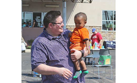 Patrick Barry, director of the Catholic Charities refugee resettlement program, with a refugee child from Eritrea during the agency’s “Mother Teresa Day of Service” – a day that honored Mother Teresa’s canonization by hosting a day of service and carnival games for refugee families and children. The theme of National Migration Week this year, Jan. 8-14, is “Creating a Culture of Encounter.”

Photo by Mary McCusker