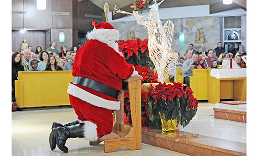 Santa Claus prays in front of the altar during Saint Gianna Beretta Molla Parish’s Christmas Eve Mass and Nativity Play. Father Anthony Manuppella, pastor of the Northfield community, celebrated the joyous liturgy.

Photo by Alan M. Dumoff