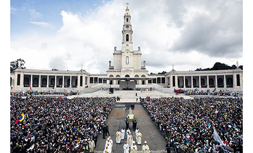 A statue of Our Lady of Fatima is carried through a crowd at the Marian Shrine of Fatima in central Portugal in this photo from last year. Thousands of pilgrims arrived at the shrine to attend the 99th anniversary of the first apparition of Mary to three shepherd children. Lucia dos Santos and her cousins, Francisco and Jacinta Marto, received the first of several visions May 13, 1917. A few seats remain for the Camden Diocesan Pilgrimage to Fatima.

CNS photo/Paulo Chunho, EPA