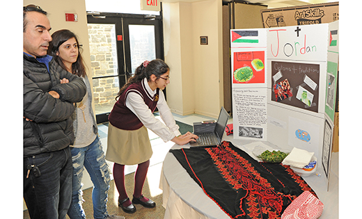 Eighth grader Christina Ayoub shows her parents a project about the country of Jordan during a cultural awareness day at Christ the King School, Haddonfield, on Jan. 30.

Photo by Alan M. Dumoff