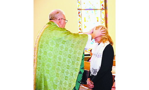 Father Edward F. Namiotka, pastor, lays hands on a woman during a Mass with anointing of the sick at Saint Joseph Church, Somers Point, on Jan. 29. The Mass was sponsored by the parish nursing ministry and Knights of Columbus Council 10220.

Photo by Alan M. Dumoff