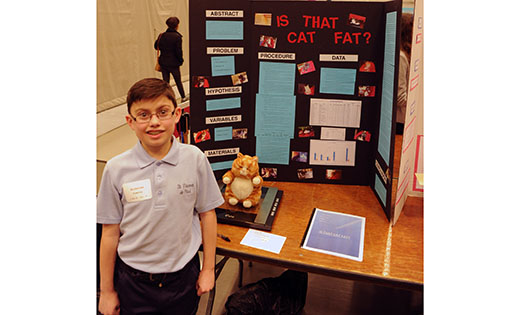 Nicholas Fleming, of Saint Vincent de Paul Regional School in Mays Landing, stands with his display of his cat body weight experiment at the science fair hosted by Stockton University.

Photo by Alan M. Dumoff