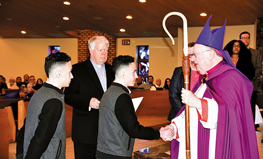 Bishop Dennis Sullivan greets catechumens Isaiah and Isaac Rodriguez at the Rite of Election March 5 at Saint Agnes Church, Our Lady of Hope Parish, Blackwood. Also pictured is Deacon Michael Scott. The Rite of Election is part of the Rite of Christian Initiation of Adults (RCIA), the process taken by individuals who want to become Christians in the Catholic tradition.

Photo by James A. McBride