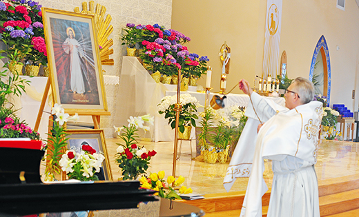 Deacon Nicholas Mortelliti censes the Divine Mercy image last Sunday at Glassboro’s Mary, Mother of Mercy Parish during the church’s Divine Mercy Sunday celebrations. Each year, on the first Sunday after Easter, Christian communities throughout the world gather to reflect on the Lord’s promise of merciful love as told to Saint Maria Faustina Kowalska.

Photo by Alan M. Dumoff