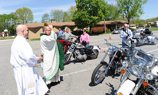 Infant Jesus’ parking lot was full of hogs last Sunday morning as the Woodbury Heights parish held its annual blessing of the motorcycles. Above, parochial vicar of the church, Father Chris Mann, with Deacon Frank Dunleavy, blesses the bikers and their rides. Below, Father Mann gets ready to roll out.

Photos by Alan M. Dumoff