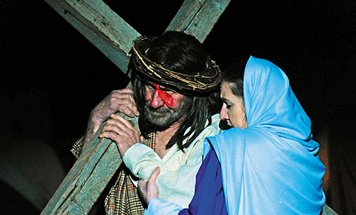 David Verna and Krista Nees portray Jesus and his mother for the outdoor stations of the cross on Good Friday, April 14, at Christ the Redeemer Parish, Atco. This is the 33rd year the stations have been staged on the ballfield near Assumption Church. Counting both actors and crew members, the production involves some 100 individuals. 

Photo by Alan M. Dumoff