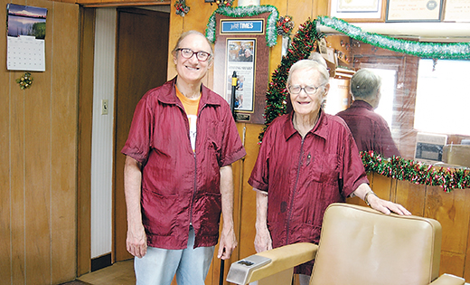 At age 100, Joseph Barca, right, still works five days a week at the barber shop he and his son, Joseph, own in Elmer. VITALity Catholic Healthcare Services is hosting a Milestone of Life Mass July 26 for those individuals 100 years of age or older.

Photo by Peter G. Sánchez