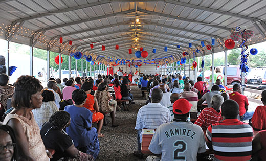 Local clergy celebrate a Mass of welcome for Haitian migrant workers at Columbia Farms in Hammonton on June 30.

Photo by Alan M. Dumoff