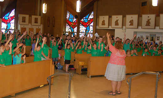 Guided by Felicia Navarro, director of Lifelong Faith Formation, 200 youth raise their hands to the heavens in worship and praise in Vineland’s Our Lady of Pompeii Church, at Vineland’s Saint Padre Pio Parish, during their Summer Intensive Program. For three weeks in June and July, the children (first through eighth grades) spent time outside of their familiar classroom setting, under outdoor tents on the parish campus to learn the Gospel.

Photo by Peter G. Sanchez