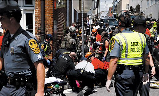 Rescue workers assist people who were injured when a car drove through a group of counter-protesters during a white nationalist rally in Charlottesville, Va., Aug. 12.

CNS photo/Joshua Roberts, Reuters