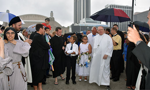 Photos by James A. McBride

A light rain falls as Bishop Dennis Sullivan and others walk on the Atlantic City beach before the bishop prepares to take a lifeboat into the surf for the annual Wedding of the Sea ceremony.