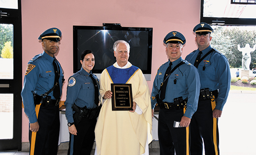 Standing with law enforcement officials, Msgr. Michael Mannion holds a plaque honoring him for “his years of service to the law enforcement and public safety  community of Southern New Jersey.” It was presented to him during the Blue Mass at Saint Agnes Church, Our Lady of Hope Parish, Blackwood, on Sept. 29.

Photo by James A. McBride