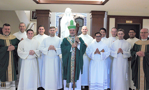Seminarians John March and Carlo Santa Teresa (back row, second and third from right) received the ministry of acolyte from Bishop Edgar da Cuhna on Sunday, Oct. 22 at Immaculate Conception Seminary.