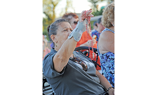 A woman holds her rosary during a prayer service at the Saint Padre Pio Shrine in Landisville on Sept. 20.

Photo by Alan M. Dumoff