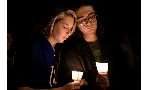 A man and woman attend a candlelight vigil after a mass shooting Nov. 5 at the First Baptist Church in Sutherland Springs, Texas.  (CNS photo/Sergio Flores, Reuters)