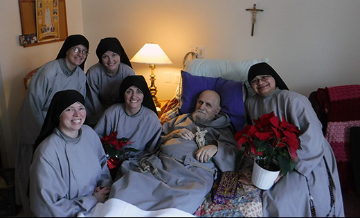 Father Andrew Apostoli is pictured with members of the Franciscan Sisters of the Renewal, an order he founded. The priest, a popular host on Eternal Word Television Network (EWTN), was born in Woodbury. He died Dec. 13 at the age of 75.