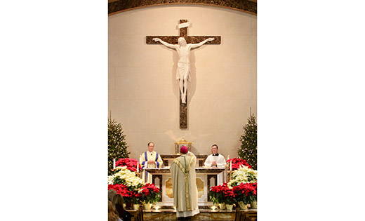 Bishop Dennis Sullivan censes the altar during Mass Dec. 24 at Incarnation Parish, Mantua. Also pictured are Deacon Peter Traum and Father Michael Romano.

Photo by Mike Walsh