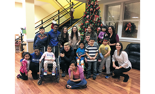 High school youth group members pose for a photo with those staying at the Ronald McDonald House of Southern NJ in Camden.