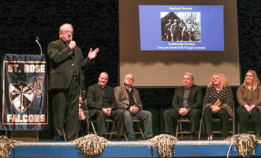 Photo by Debbie Troy

Bishop Dennis Sullivan speaks at the Falcon Fest at the Saint Rose of Lima School gym, Haddon Heights, on Jan. 27. The bishop was one of several people honored at the event. To the right of the bishop is Father E. Joseph Byerley, pastor of Saint Rose of Lima Parish.