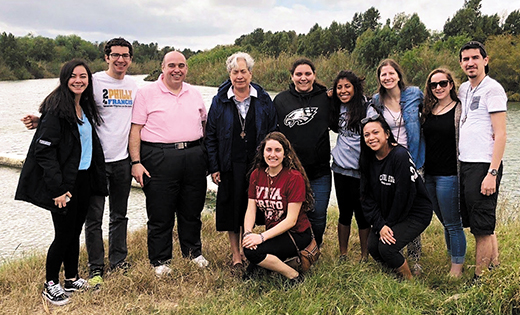 Sister Norma Pimentel, executive director of Catholic Charities of the Rio Grande Valley, Texas, poses for a photo with college students and adults from the Camden Diocese.
