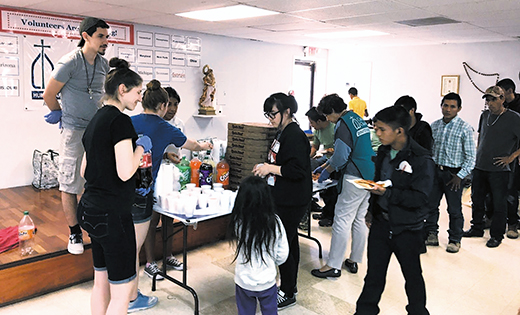 Volunteers from the Diocese of Camden work at the Catholic Charities Respite Center in McAllen, Texas. The center provides immigrants crossing the border with a place to rest, have a warm meal, a shower, and change into clean clothing as well as receive medicine and other supplies.