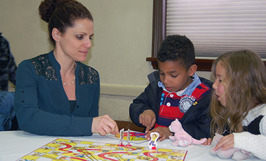 Photo by Peter G. Sánchez
Danielle Delmonaco plays Chutes and Ladders (with a twist), with her children Christian and Olivia April 15 at Saint Clare of Assisi Parish’s family-oriented event on empathy.
