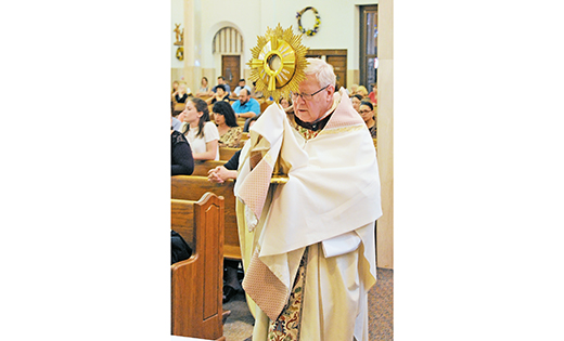 — Msgr. John H. Burton, pastor of Christ the Good Shepherd Parish, Vineland, carries the monstrance containing the Blessed Sacrament on June 3, the feast of the Body and Blood of Christ.

Photo by Alan M. Dumoff