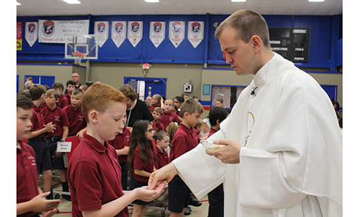Newly ordained and alumnus of Saint Catherine of Siena class of 2005, Father Joshua Nevitt celebrated an end-of-the school year Mass at Saint Michael the Archangel Regional School, Clayton.