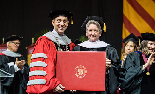 Sister Helen Cole, SSJ, was awarded an Honorary Doctorate of Humane Letters from Saint Joseph University at its 2018 commencement on May 19. She is pictured with university president Mark C. Reed. Sister Helen has served in Camden for almost 30 years. In 1995 she founded Guadalupe Family Services, offering clinical counseling and direct social services for families. She primarily works as a grief counselor for families of murder victims.