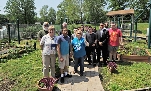 Students, volunteers and dignitaries stand in the garden at Archbishop Damiano School, Westville Grove. The garden, started in 2008, now has a paved pathway for students who use wheelchairs.

Photo by Alan M. Dumoff