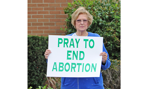 Pro-life activists stand on the White Horse Pike in front of Saint Lawrence Church, Our Lady of Guadalupe Parish Shrine, Lindenwold, on Oct. 6. Life chains were held that day in all six counties of the Diocese of Camden, and in some counties in multiple locations.