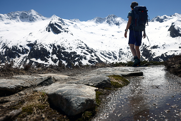 A hiker is seen in front of snow-covered mountains in the Zillertal Alps, near the village of Ginzling, Austria, June 1, 2021. (CNS photo/Lisi Niesner, Reuters)