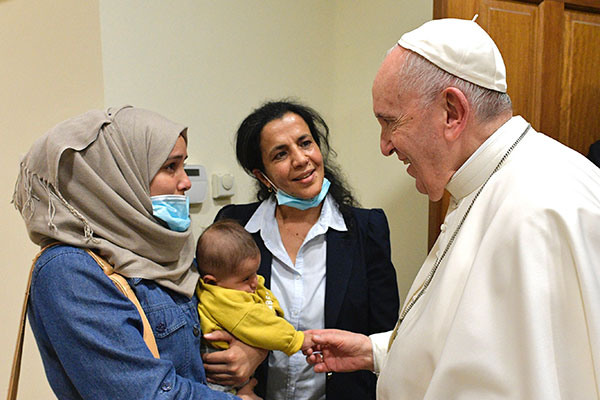 Pope Francis greets migrant families Dec. 4 at the apostolic nunciature in Athens, Greece (CNS photo/Vatican Media)