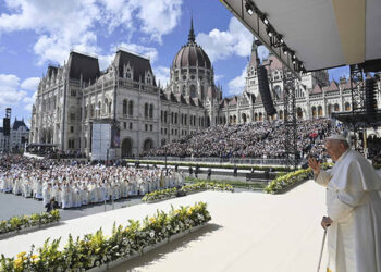 Pope Francis waves after celebrating Mass with about 50,000 people in Budapest's Kossuth Lajos Square, with the Hungarian Parliament building in the background, April 30, 2023. (CNS photo/Vatican Media)