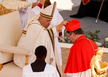 Pope Francis places a red biretta on the head of new Cardinal Christophe Pierre, nuncio to the United States, during a consistory for the creation of 21 new cardinals in St. Peter's Square at the Vatican Sept. 30, 2023. (CNS photo/Lola Gomez)