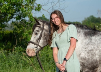 Photo courtesy of Avery Wyckoff
Julia Dodson poses with the first pony she ever rode during a senior portrait session recently.