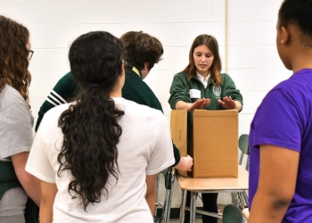 Courtesy photos
Senior Abigail Riley talks to middle school students during the 2026 iDesign Competition event. In late April, 11 teams from local middle schools took part in the competition. Hosted annually by Camden Catholic, the competition encourages the use of design thinking to imagine, create and innovate in order to solve a common problem.