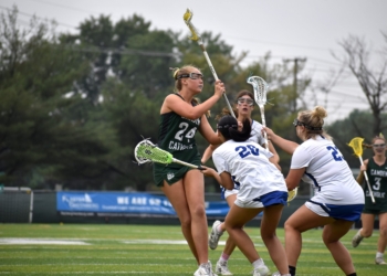 Photos by Mark Zimmaro
Camden Catholic junior Kat Gillern draws three defenders before making a pass in a 24-6 win over Donovan Catholic High School, Toms River.