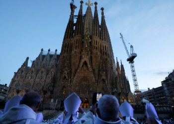 OSV News photo/Nacho Doce, Reuters
Clergy stand outside the Basilica of the Sagrada Familia in Barcelona on June 10, the day of the inauguration and blessing of the Tower of Jesus Christ (seen atop center).