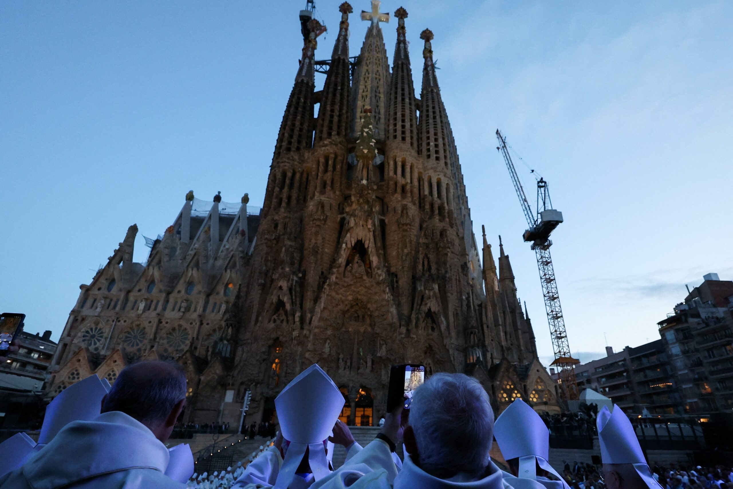 OSV News photo/Nacho Doce, Reuters
Clergy stand outside the Basilica of the Sagrada Familia in Barcelona on June 10, the day of the inauguration and blessing of the Tower of Jesus Christ (seen atop center).